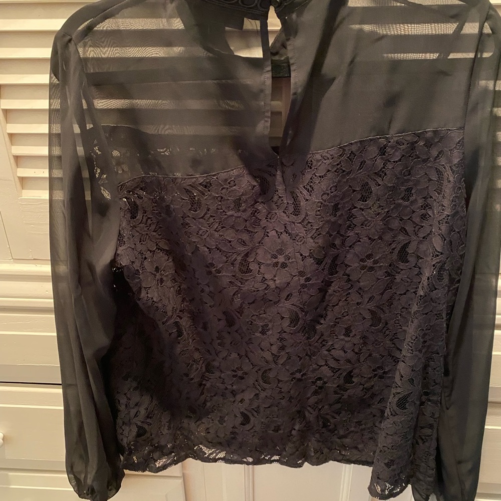 Large black lace blouse .